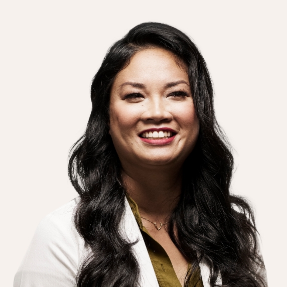 Female Heartland Supported Doctor with long dark hair and a green shirt