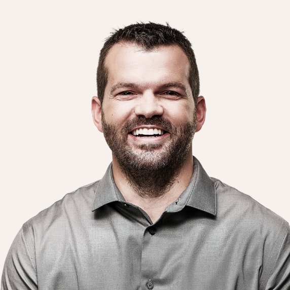 Close up of confident male dentist wearing a grey polo