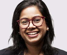Close up of confident smiling female dentist wearing glasses