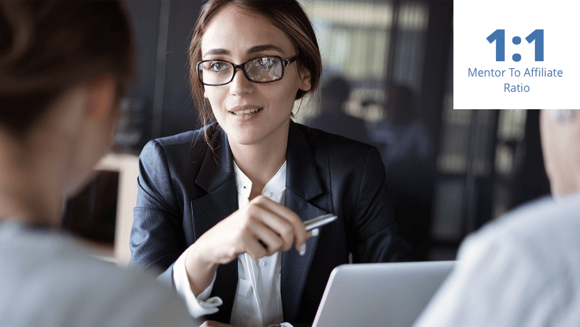 Young female professional in blue business suit talking to a husband and wife