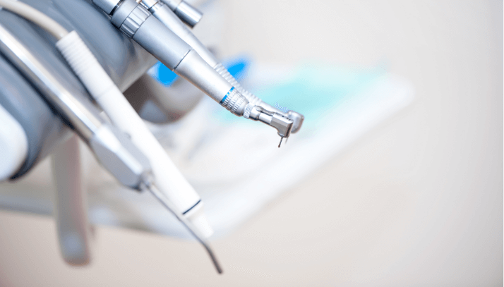 Closeup of four silver metal dental cleaning tools