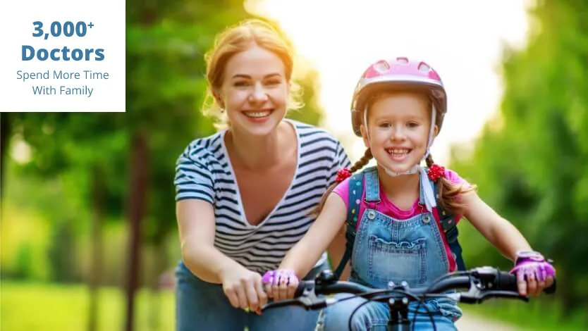 Mother teaching daughter how to ride a bike